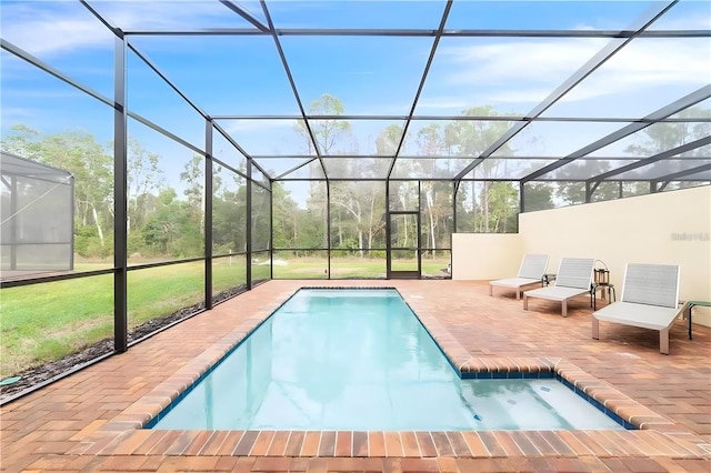 view of pool featuring a patio and glass enclosure