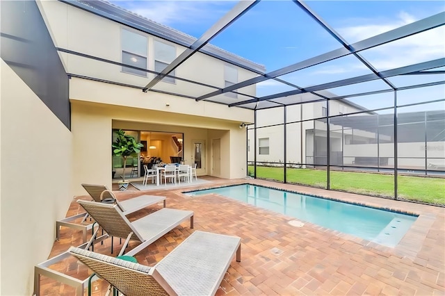 view of swimming pool with a lanai and a patio