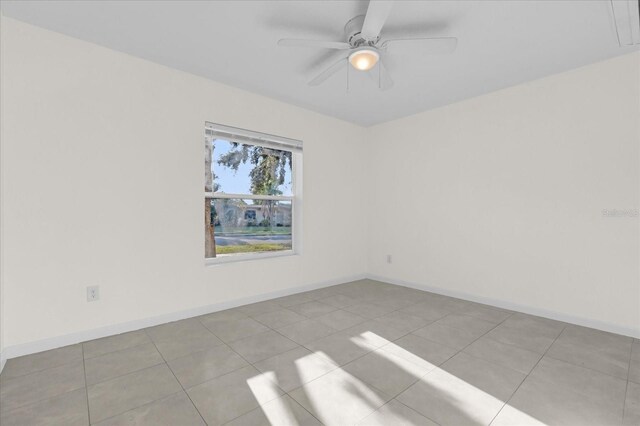 unfurnished room with light tile patterned flooring and ceiling fan