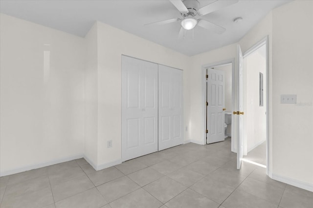 unfurnished bedroom featuring ceiling fan, a closet, and light tile patterned floors