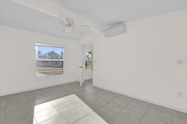 unfurnished room featuring beamed ceiling, ceiling fan, a wall mounted AC, and light tile patterned floors