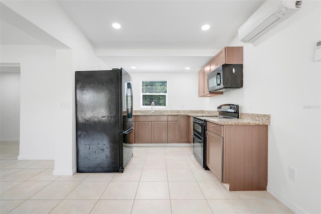2341 Hadley St, Deltona, FL 32738 - kitchen featuring black appliances, a sink, a wall unit AC, recessed lighting, and light stone countertops