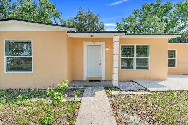 2341 Hadley St, Deltona, FL 32738 - property entrance with stucco siding and a patio area