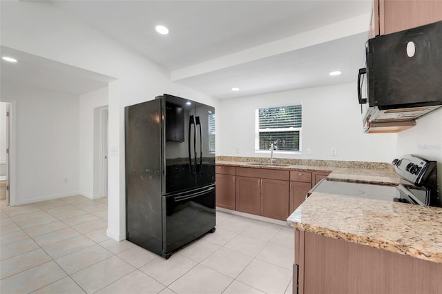 2341 Hadley St, Deltona, FL 32738 - kitchen with black appliances, a sink, recessed lighting, light tile patterned flooring, and brown cabinetry