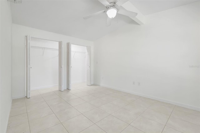 2341 Hadley St, Deltona, FL 32738 - unfurnished bedroom with vaulted ceiling, two closets, light tile patterned floors, a ceiling fan, and baseboards