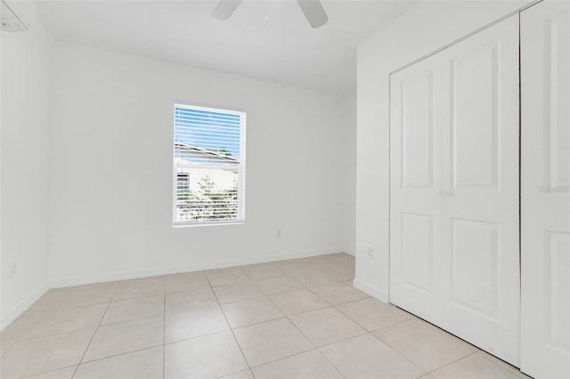 2341 Hadley St, Deltona, FL 32738 - unfurnished bedroom featuring a wall unit AC, light tile patterned flooring, and baseboards