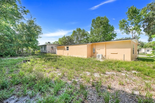 2341 Hadley St, Deltona, FL 32738 - back of property featuring stucco siding and cooling unit