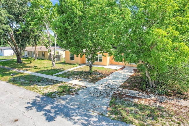 2341 Hadley St, Deltona, FL 32738 - view of front of house with concrete driveway, stucco siding, and a front lawn