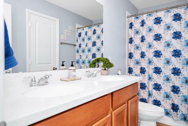 bathroom with vanity, a shower with shower curtain, and toilet