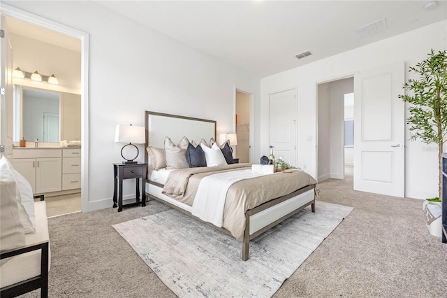 carpeted bedroom with ensuite bathroom