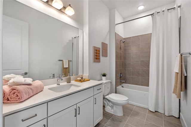 full bathroom with tile patterned floors, vanity, toilet, and shower / bath combo with shower curtain