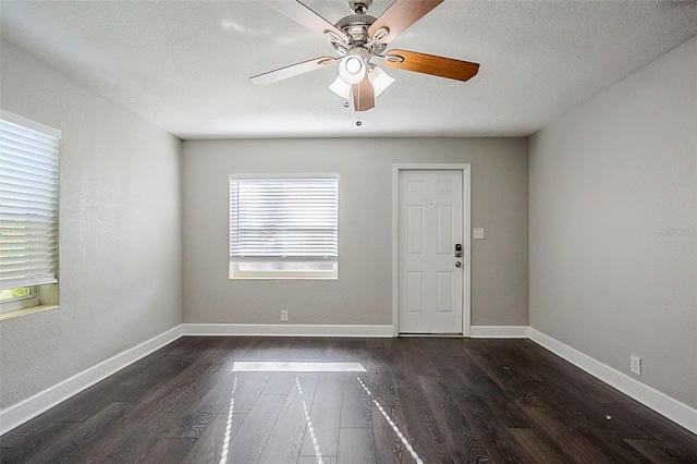 unfurnished room with ceiling fan and dark hardwood / wood-style floors