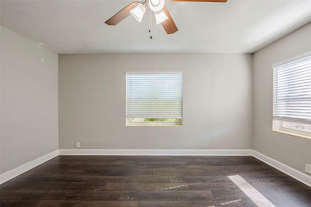 empty room featuring dark hardwood / wood-style floors and ceiling fan