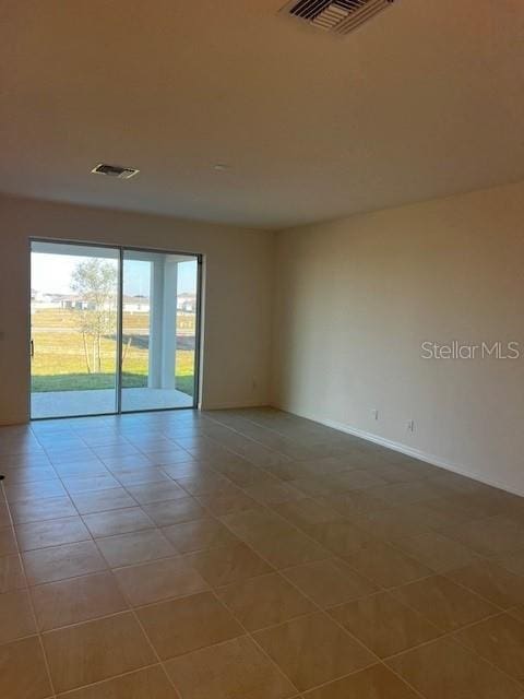 unfurnished room with light tile patterned floors