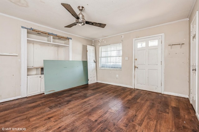 entryway with ceiling fan, ornamental molding, wood-type flooring, and baseboards