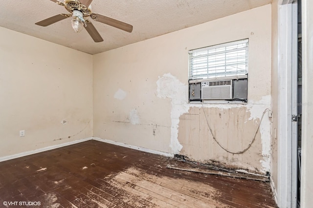 empty room with a ceiling fan, cooling unit, a textured ceiling, and hardwood / wood-style flooring