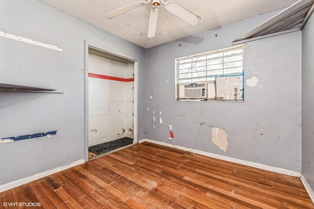 spare room with baseboards, a textured ceiling, a ceiling fan, and hardwood / wood-style floors