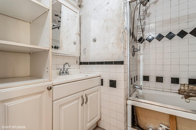 bathroom with  shower combination, vanity, and tile walls