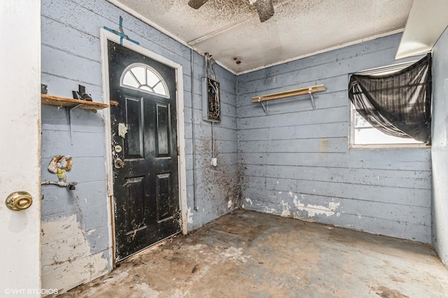 entryway with unfinished concrete flooring