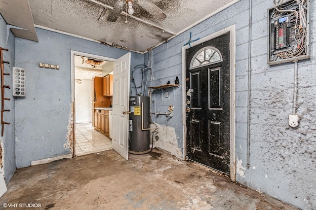 foyer entrance with concrete block wall, unfinished concrete flooring, and electric water heater