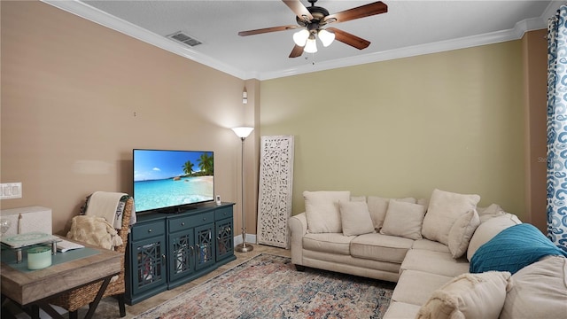 living room with ceiling fan and crown molding