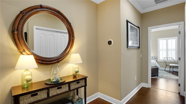 hall with dark hardwood / wood-style floors and crown molding