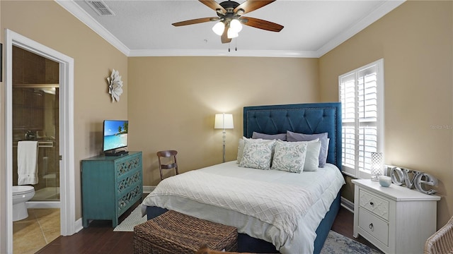 bedroom featuring connected bathroom, ceiling fan, dark hardwood / wood-style flooring, and crown molding