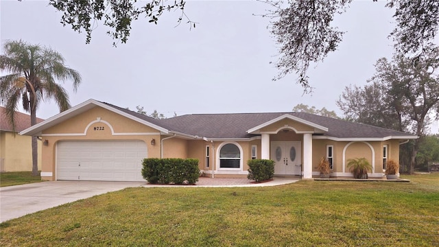 ranch-style house featuring a garage and a front lawn