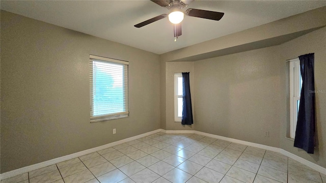 tiled empty room with ceiling fan