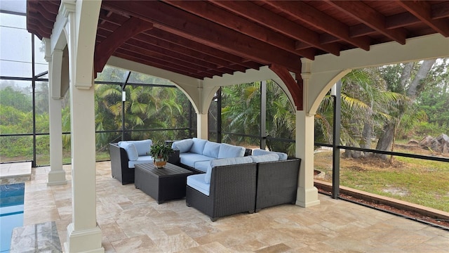 view of patio with outdoor lounge area and glass enclosure