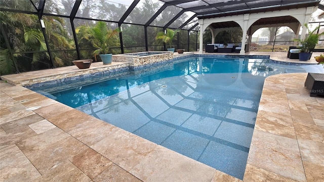 view of swimming pool featuring an in ground hot tub, a patio, and a lanai