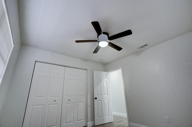 unfurnished bedroom with a closet, ceiling fan, and light hardwood / wood-style floors