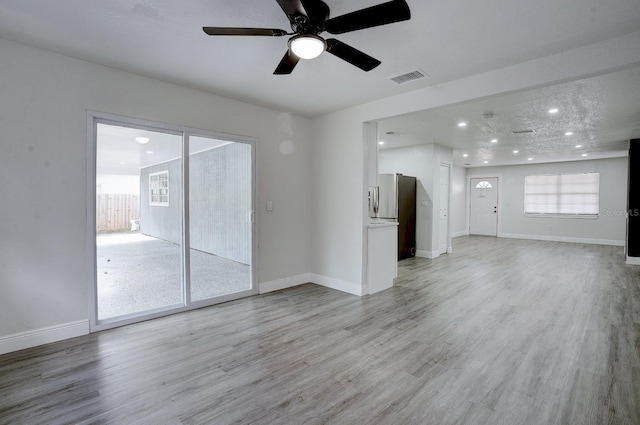 unfurnished living room with light hardwood / wood-style floors, plenty of natural light, and ceiling fan