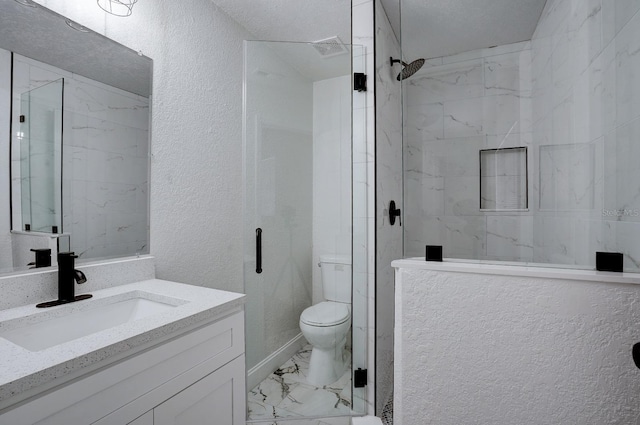 bathroom featuring a shower with door, vanity, and toilet