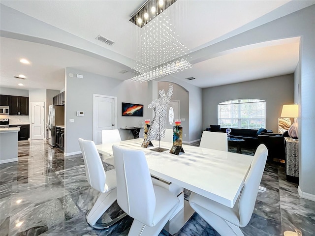 dining area featuring a notable chandelier