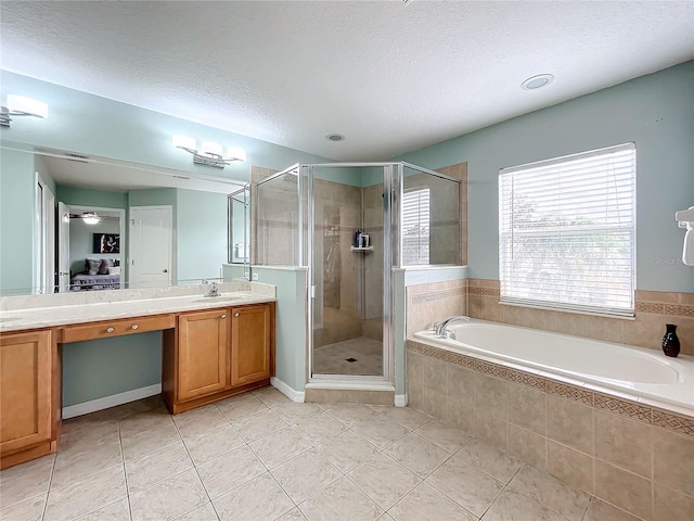 bathroom with separate shower and tub, tile patterned flooring, vanity, and a textured ceiling