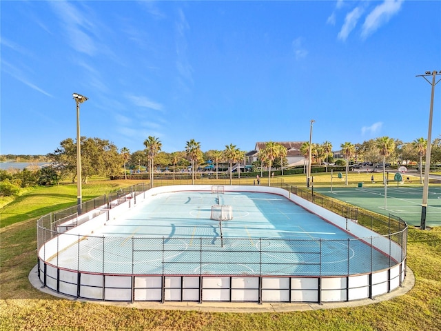 view of swimming pool featuring tennis court