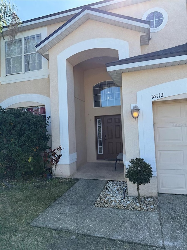 view of exterior entry featuring a garage