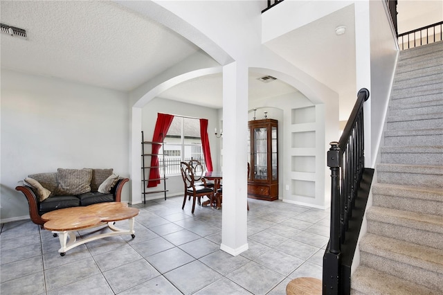 tiled entrance foyer featuring a textured ceiling