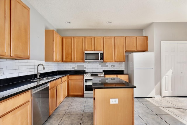 kitchen featuring light tile patterned flooring, appliances with stainless steel finishes, tasteful backsplash, sink, and a center island