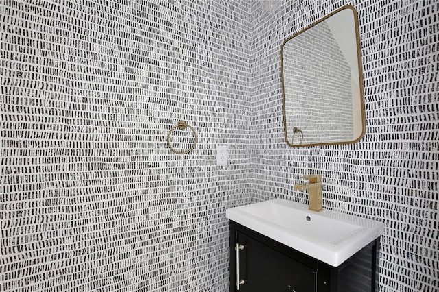 bathroom with vanity and tile walls