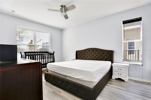 bedroom with ceiling fan and light hardwood / wood-style floors