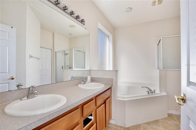 bathroom featuring tile patterned flooring, vanity, and shower with separate bathtub