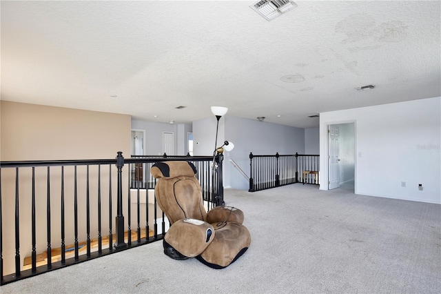 sitting room featuring light carpet and a textured ceiling