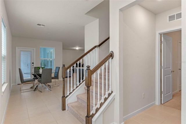 staircase featuring plenty of natural light