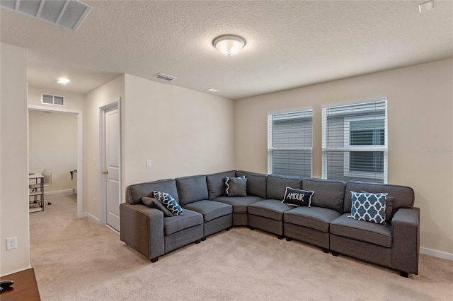 living room with light colored carpet and a textured ceiling