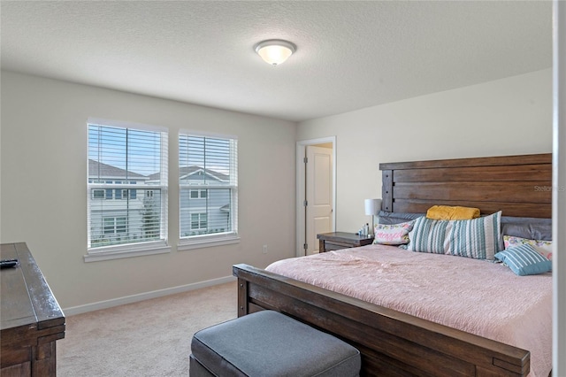 carpeted bedroom featuring a textured ceiling