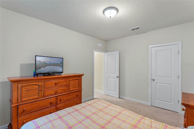 carpeted bedroom with a textured ceiling