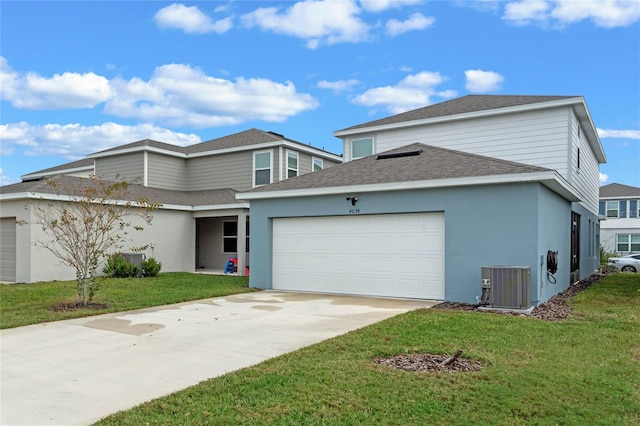 front facade featuring a front lawn, a garage, and central AC unit