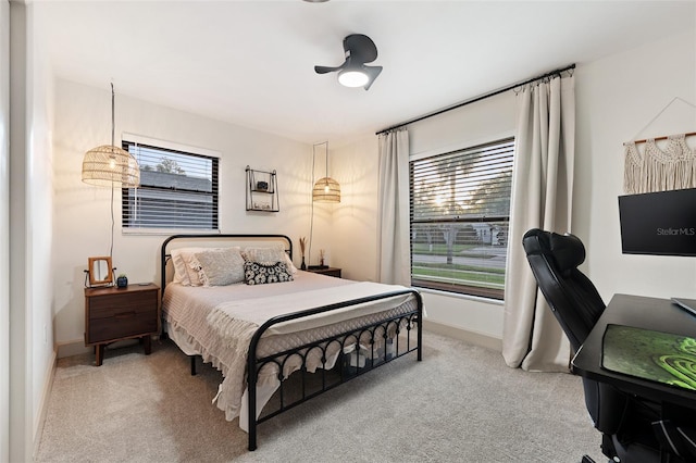 bedroom featuring ceiling fan and light carpet